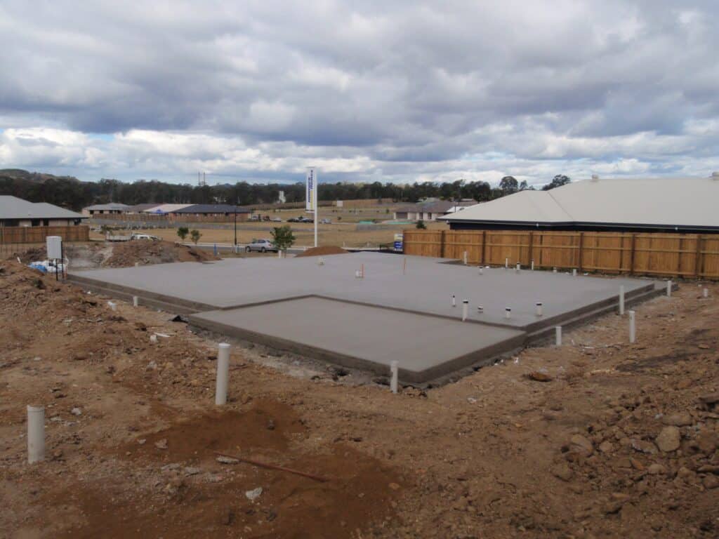 A newly poured concrete slab for a house with a patio area